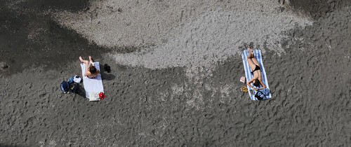 Sunbathing on the black volcanic sand in Sorrento