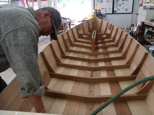 GEDC7649 - Port Hadlock WA - Northwest School of Wooden Boatbuilding - Traditional Small Craft - Carolina Spritsail Skiff - cleaning the boat before painting it with primer - student Mark Paxton