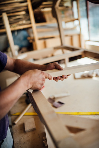 Carpenter fitting furniture parts together. Making furniture in a workshop