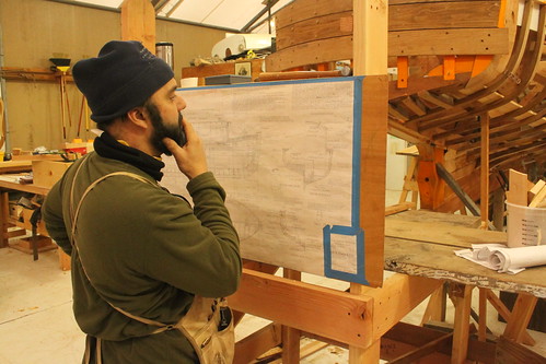 Port Hadlock WA - Boat School - Traditional Large Craft - Forest Service Boat - Instructor Tim Lee studies the construction plans