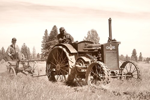 Willie and son, running an antique plow behind an antique Case tractor