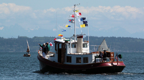 IMG_7606CE - Port Townsend Bay - PTYC Opening Day - aboard BLUE STAR - Port Townsend Yacht Club (PTYC) Victory Tug LADY (up and over flags flying) leads off the parade while SCAMP 74 SV HUMA passes outboard