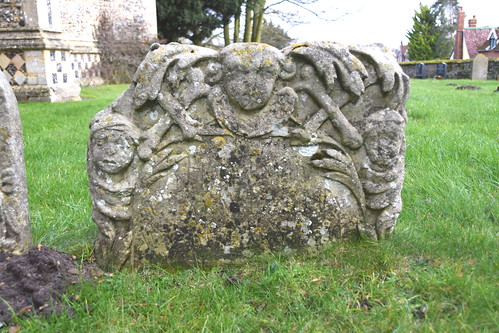 fronded cherub flanked by crossed bones and shrouded corpses (early 18th Century)