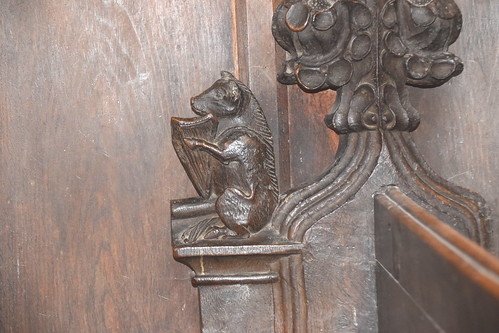 bench end: pig playing a harp (15th Century)