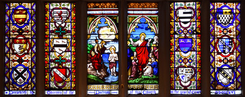 Baptism of Christ, of Such is the Kingdom flanked by heraldic glass of donors (David Evans of Shrewsbury, 1856)