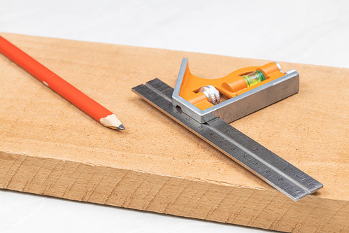 Combination square with wooden pencil on the wooden board