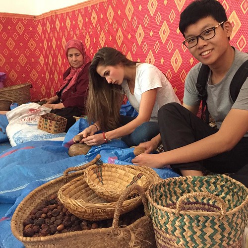 Salome and Tianxiao crack open an argan fruit (Essaouira, Morocco)