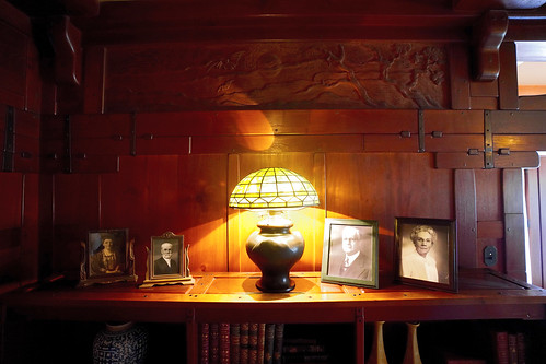 Gamble family photos below richly carved redwood frieze and beautiful joinery