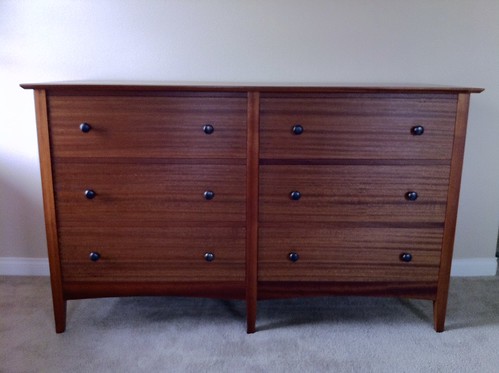 The knobs are a brushed bronze that give the dresser a somewhat asian feel