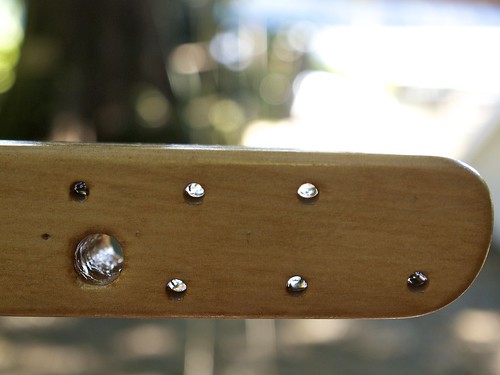 hot-coat spars with 2nd coat of epoxy, boom detail, forward end showing tack and reefing hardware mounts