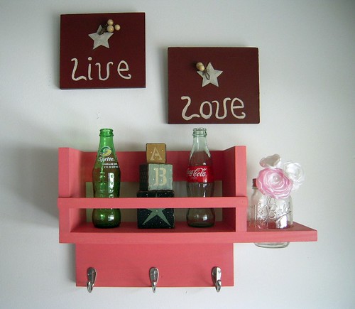 Rose petal pink bathroom organizer with satin nickel hooks and a flower vase